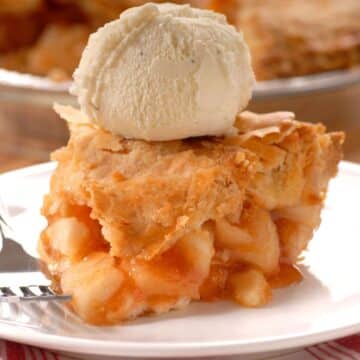a slice of apple pie with a scoop of ice cream on top
