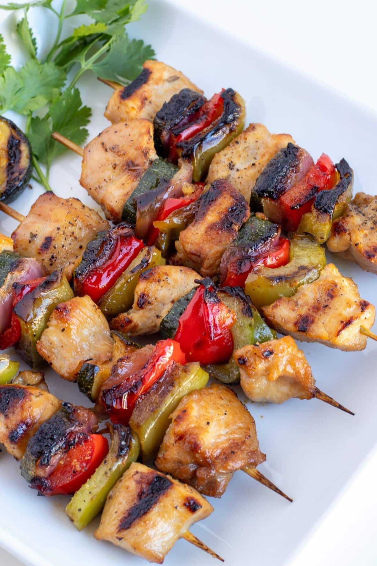 chicken kabobs with vegetables on a plate