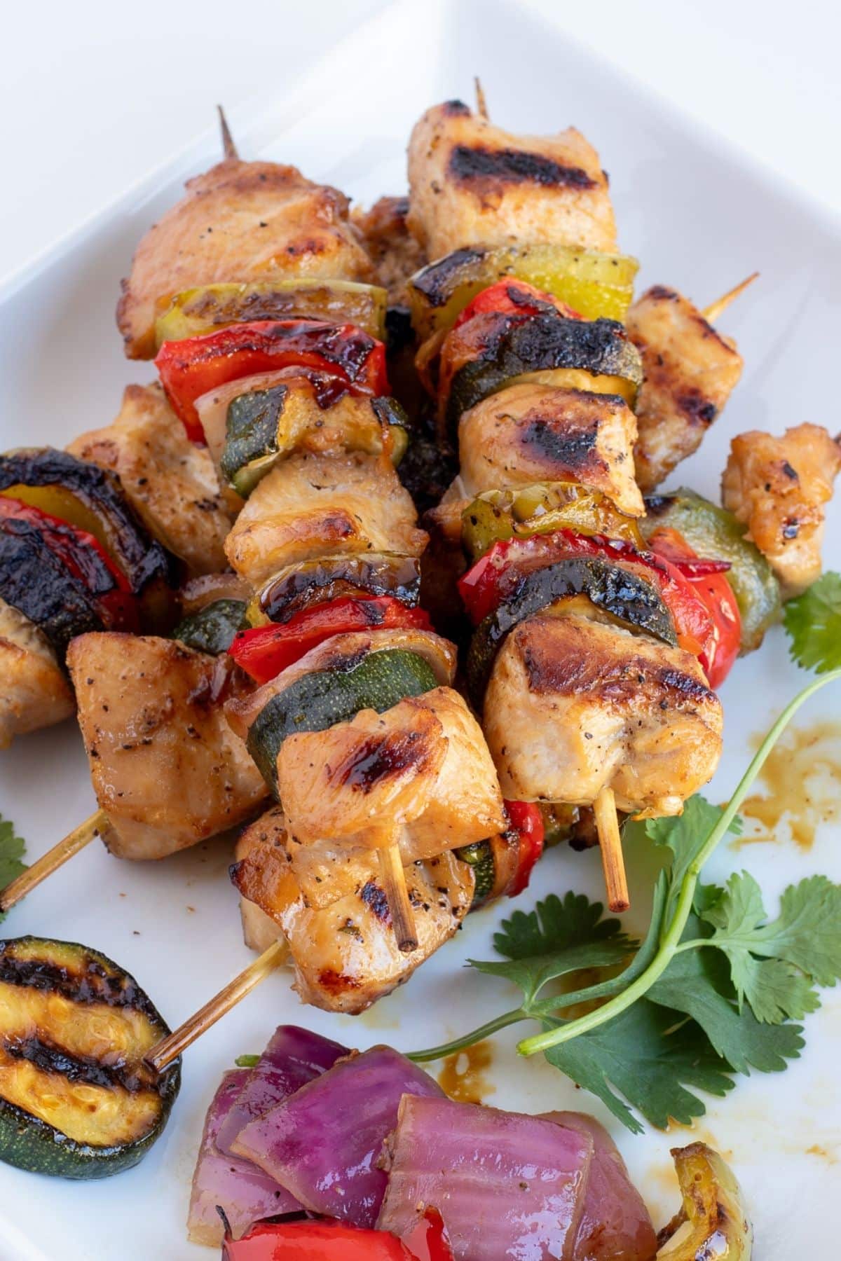 chicken kabobs with vegetables on a plate