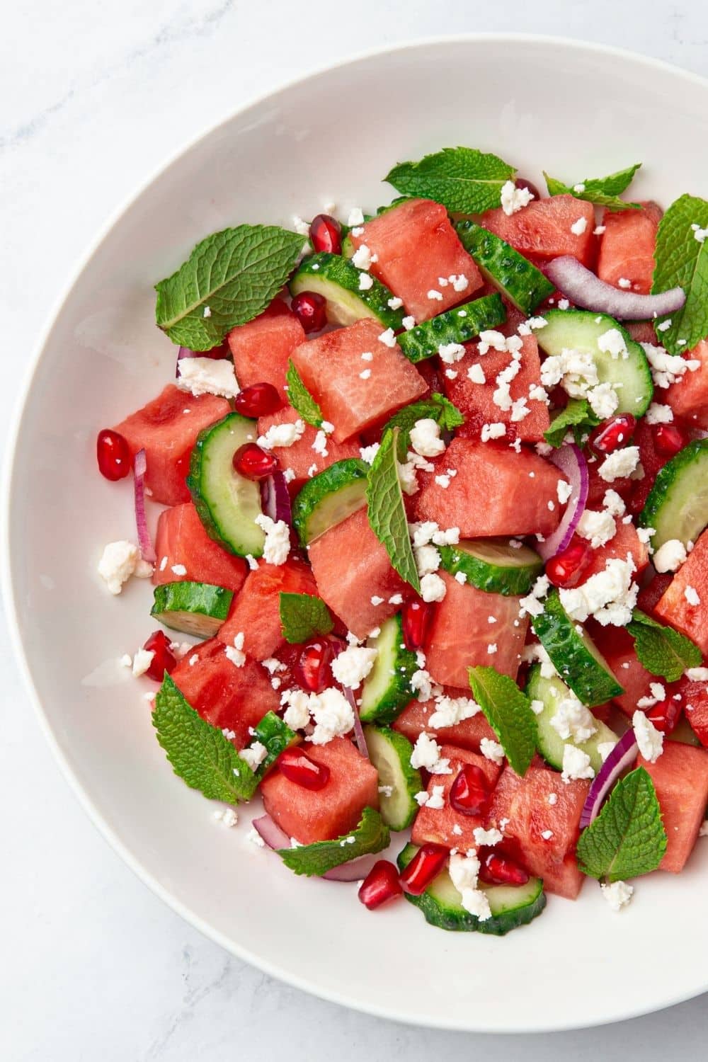 watermelon feta salad with cucumber, mint leaves and pomegranate seeds