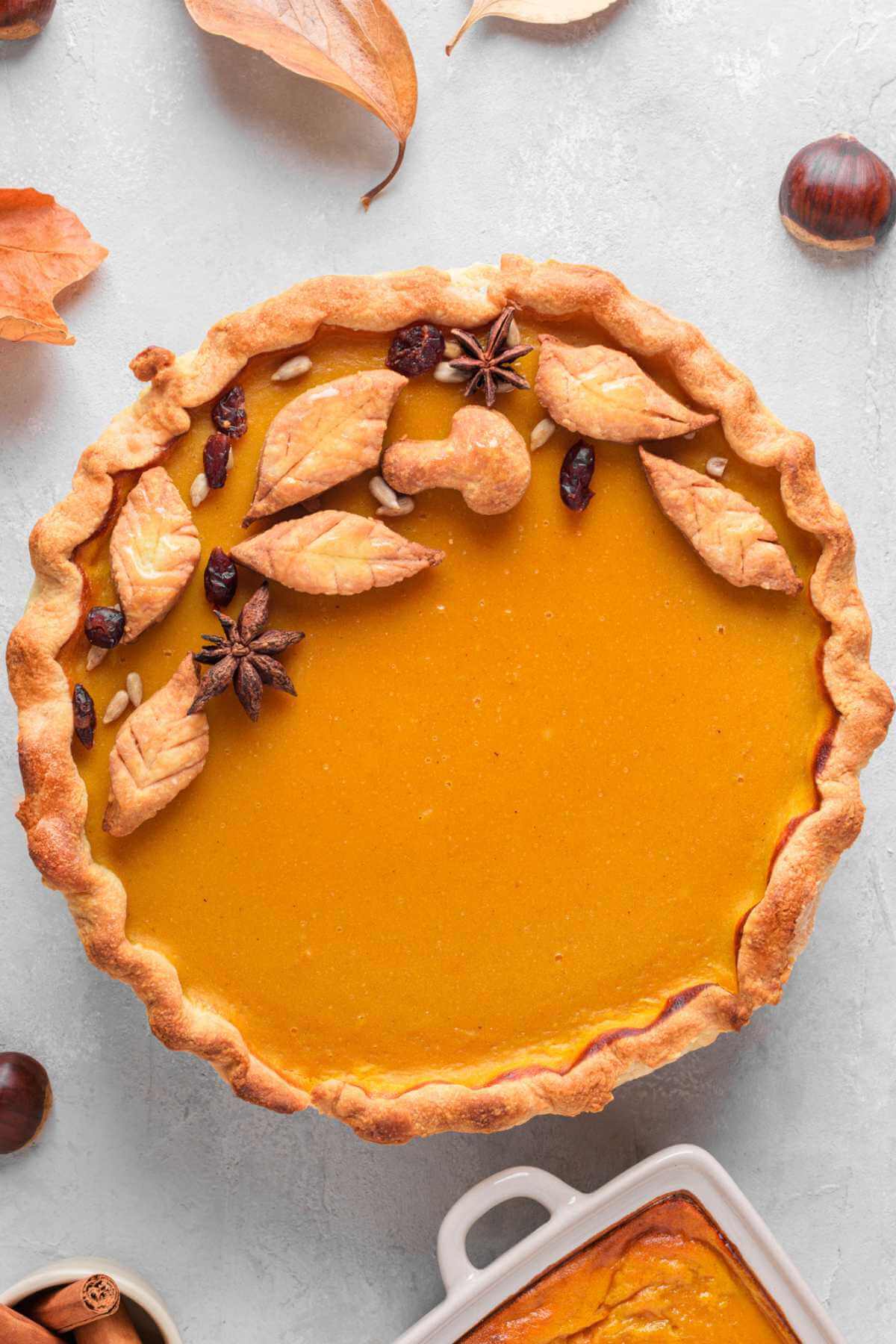 a whole pumpkin pie with leaf decorations