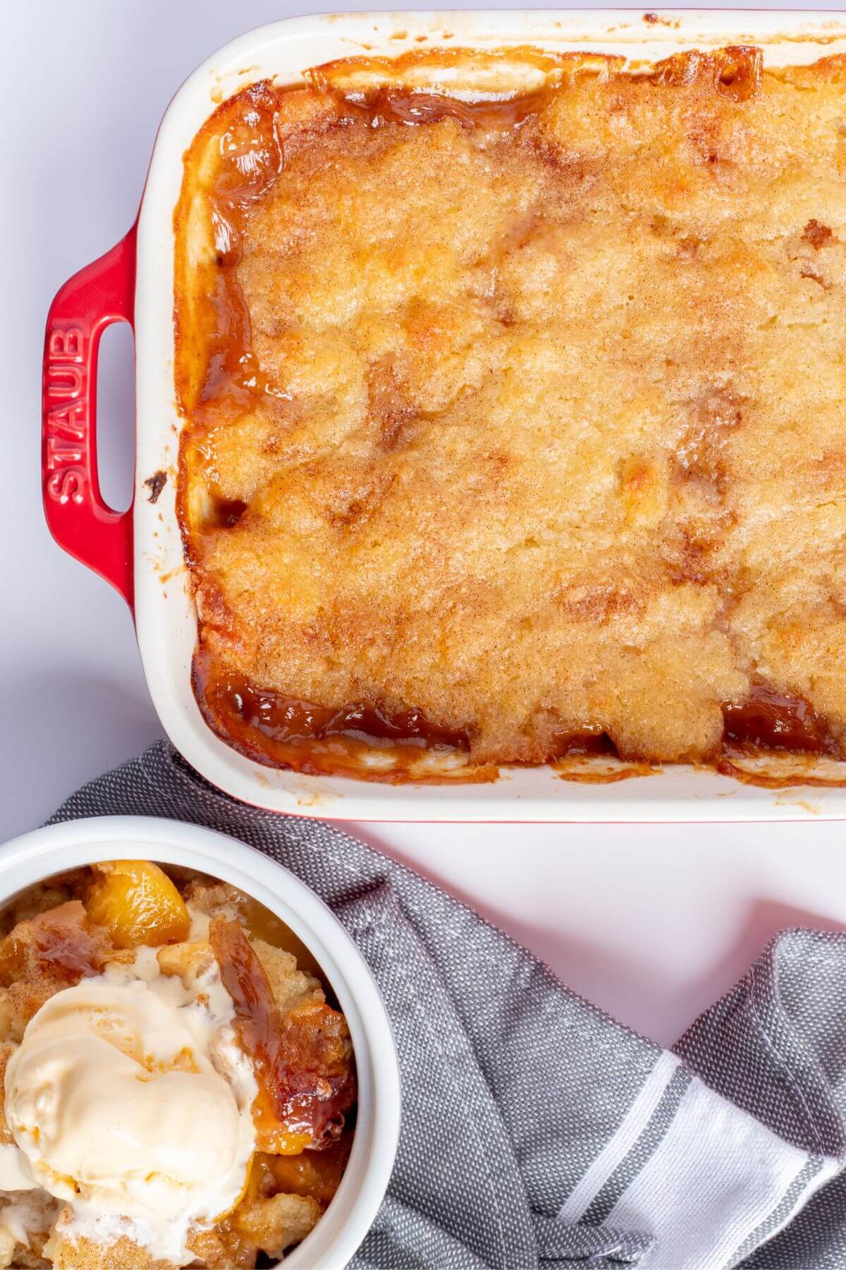 easy peach cobbler with canned peaches on a bking dish an ramekin